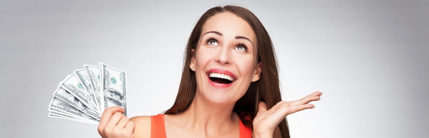 A happy woman holding a lot of money with her hand.