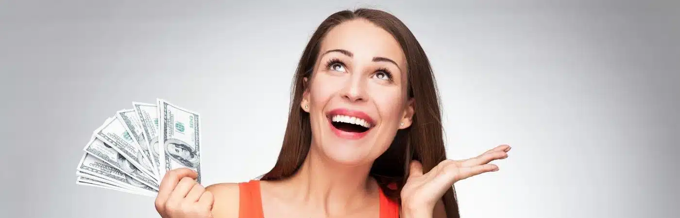 A happy woman holding a lot of money with her hand.